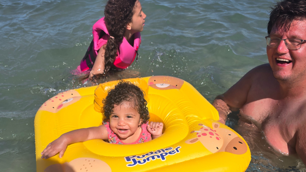 Dad enjoying the beach with his two daughters