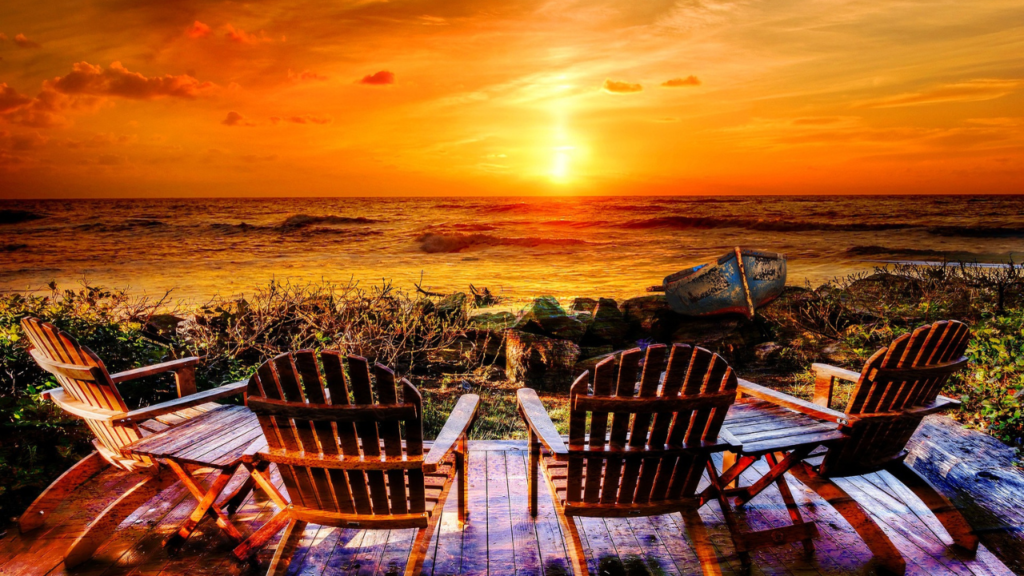 choosing-the-right-beach-chairs-and-loungers-matters - Plastic lounging beach chairs in the sunset on the beach